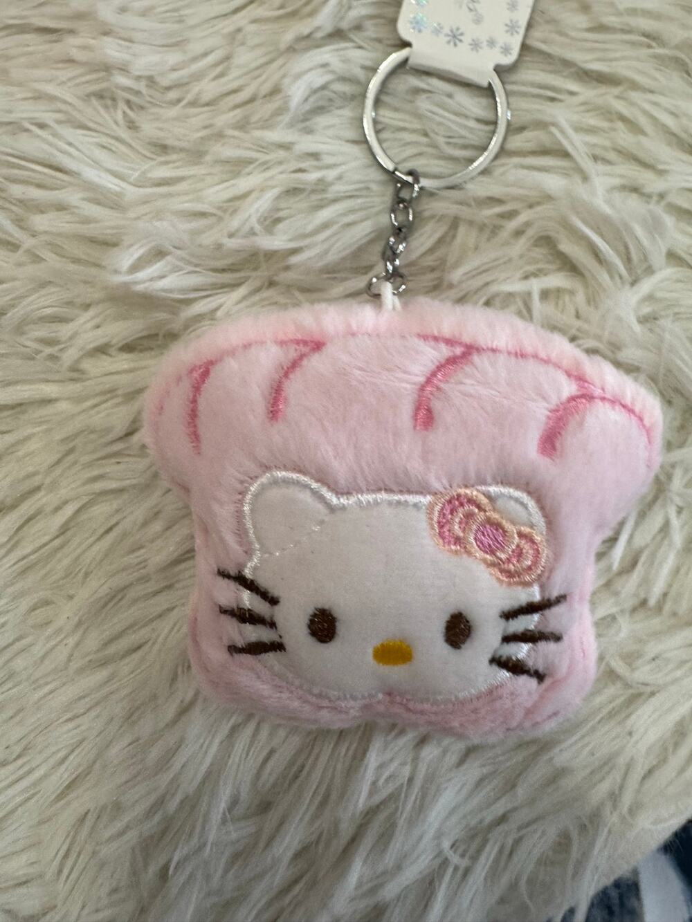 Sanrio Hello Kitty pink plush keychain bread slide with Hello Kitty face